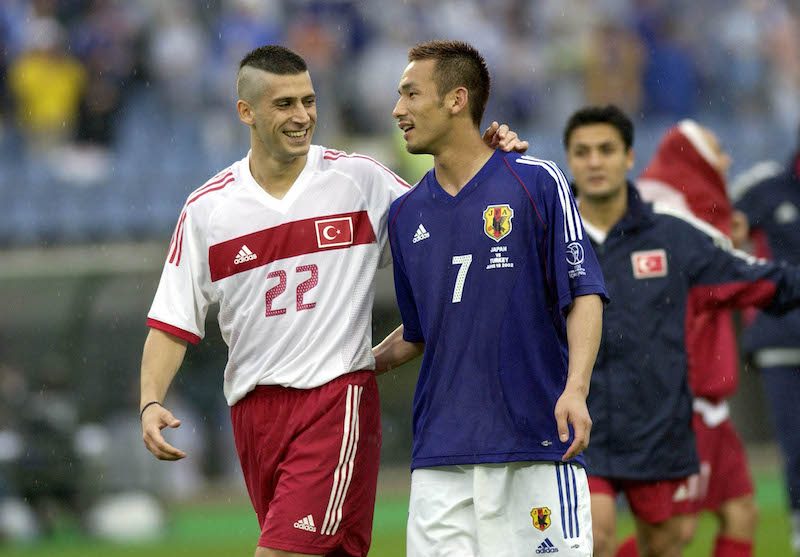 BT Football. FIFA World Cup Finals. Miyagi, Japan. 18th June 2002. Japan 0 v Turkey 1. Turkey's goalscorer Umit Davala consoles Japan's Hidetoshi Nakata after the match