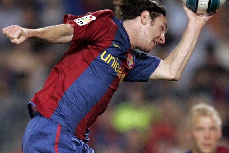 Barcelona's Leo Messi scores with his hand against Espanyol during their Spanish First Division Soccer League match at Nou Camp Stadium in Barcelona